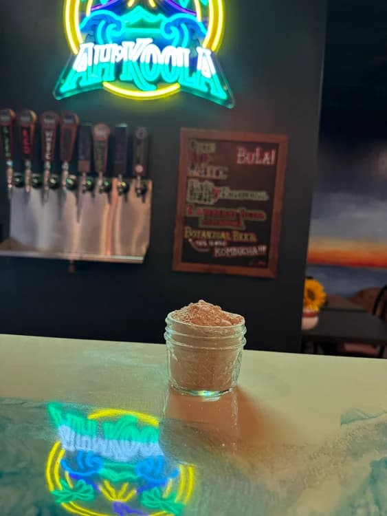 Noble Tea Kava’s Ah’Koola instant powder shown in a small glass at the bar