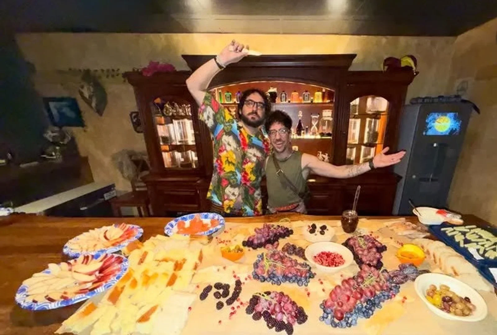 People behind Moon and Root’s bar with a spread of colorful food in front